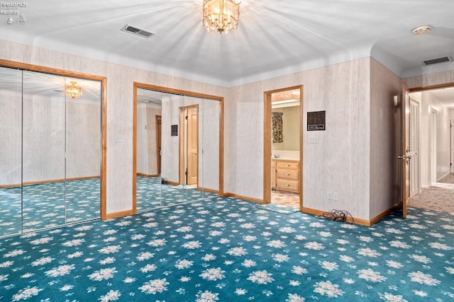 basement featuring carpet floors and an inviting chandelier