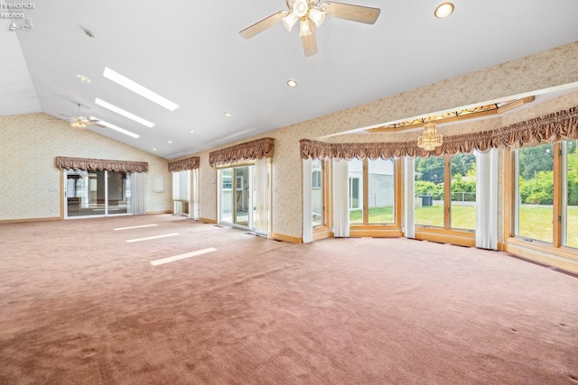 unfurnished living room featuring ceiling fan, carpet, and vaulted ceiling with skylight