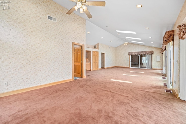 unfurnished living room featuring light colored carpet, high vaulted ceiling, and ceiling fan