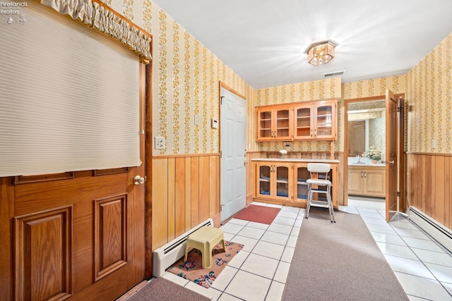 mudroom featuring light tile patterned flooring and baseboard heating