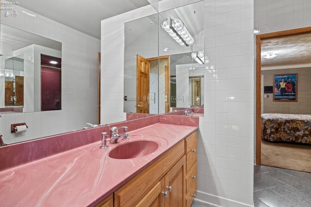 bathroom with vanity, tile patterned floors, and tile walls