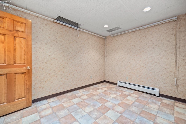 spare room with a baseboard radiator and light tile patterned floors