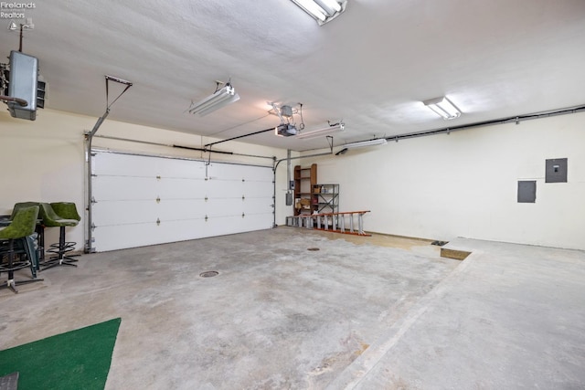 garage with electric panel and a garage door opener