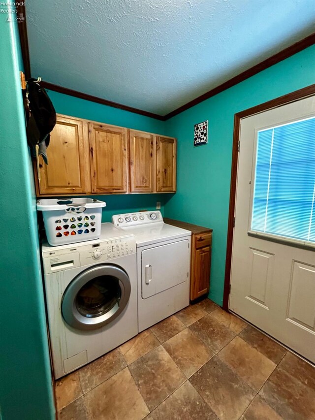 clothes washing area with independent washer and dryer, crown molding, cabinets, and tile patterned floors