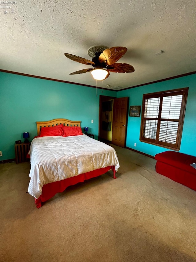 carpeted bedroom with a ceiling fan, a textured ceiling, baseboards, and crown molding