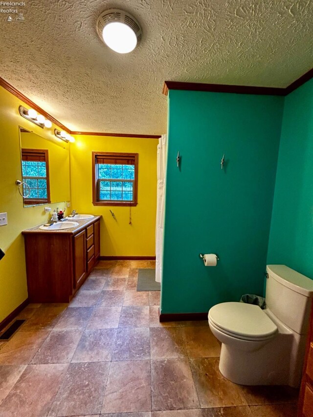 bathroom with toilet, a textured ceiling, tile patterned flooring, and vanity