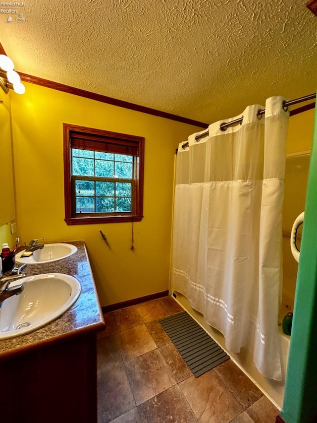 full bath featuring shower / bathtub combination with curtain, a sink, a textured ceiling, and double vanity