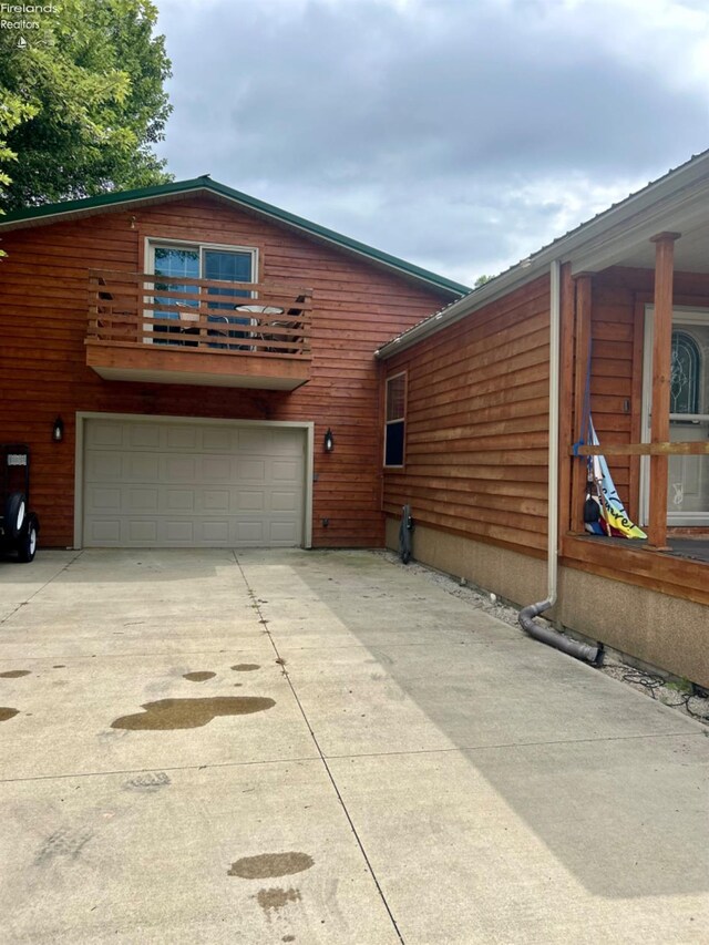 view of front of house featuring a garage and a balcony