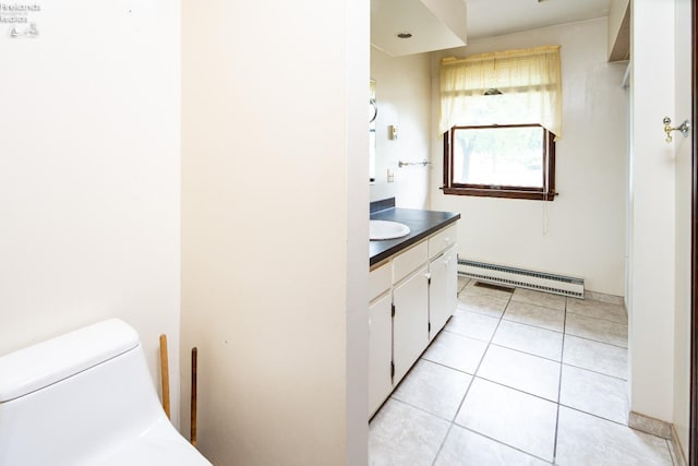 bathroom with tile patterned floors, vanity, baseboard heating, and toilet