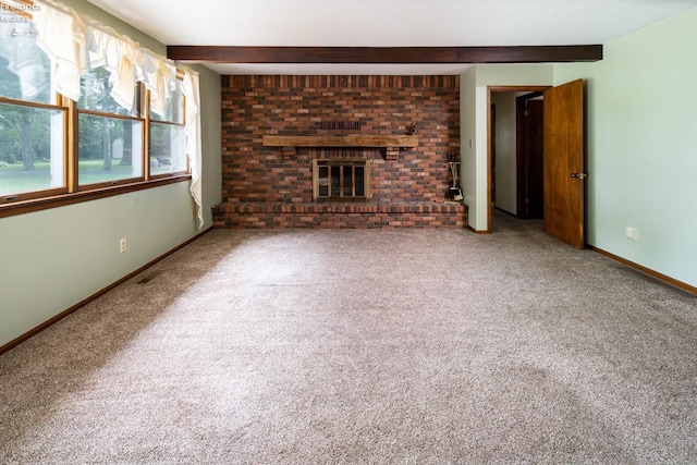 unfurnished living room with a fireplace, carpet, and beam ceiling