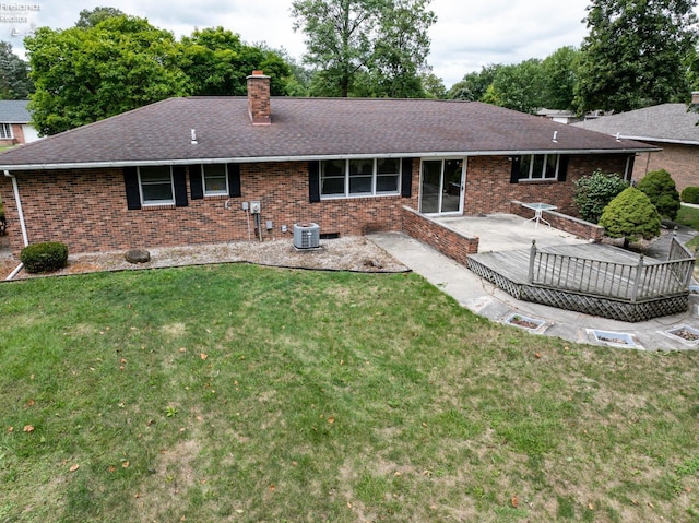 back of property featuring a patio area, a lawn, and cooling unit