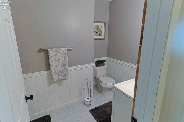 bathroom featuring tile patterned floors, vanity, and toilet