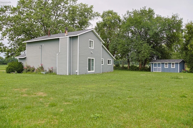 view of side of property featuring an outdoor structure and a lawn