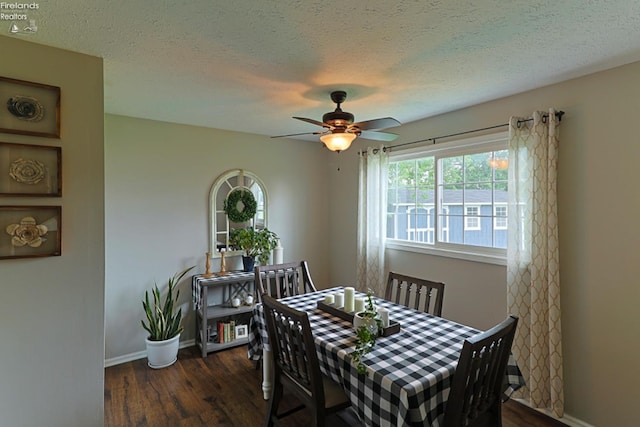 dining space featuring dark hardwood / wood-style floors, ceiling fan, and a textured ceiling