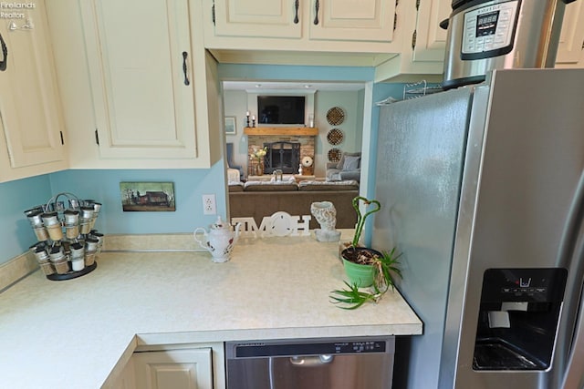 kitchen with a fireplace and stainless steel appliances