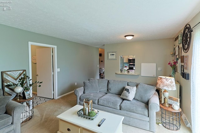 living room with a textured ceiling and light colored carpet