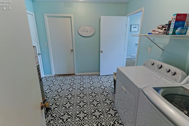 washroom with washing machine and clothes dryer and tile patterned floors