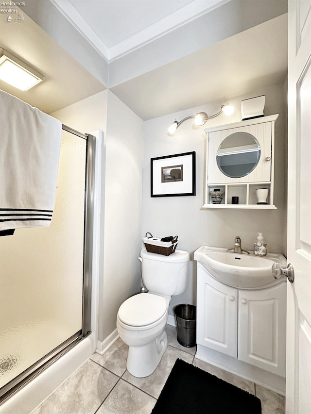 bathroom featuring walk in shower, vanity, tile patterned flooring, and toilet