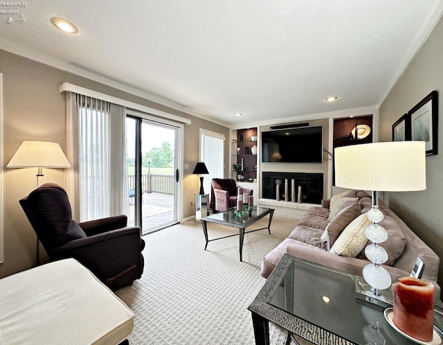 living room featuring built in shelves, ornamental molding, and carpet