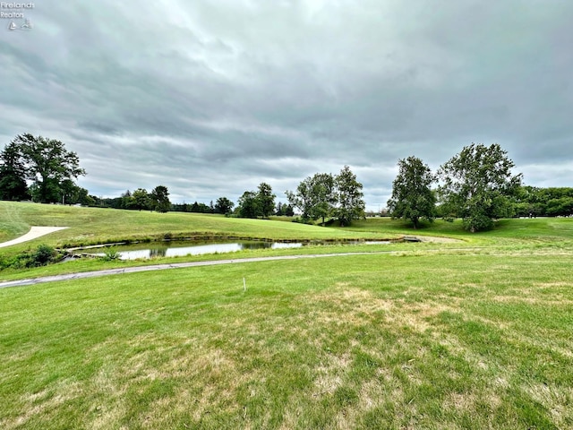 view of home's community featuring a yard and a water view