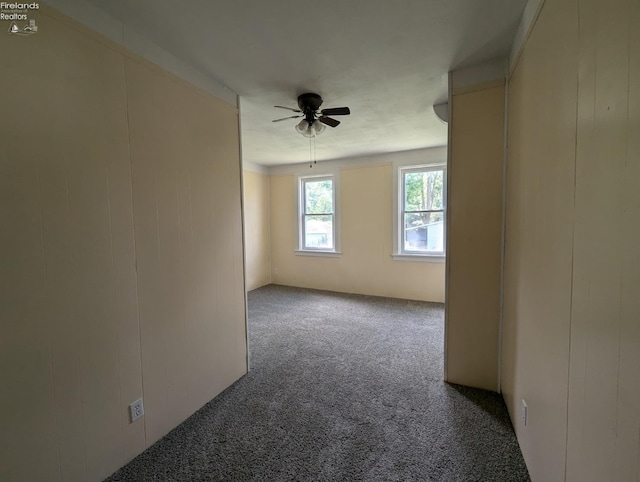 spare room with ceiling fan and carpet