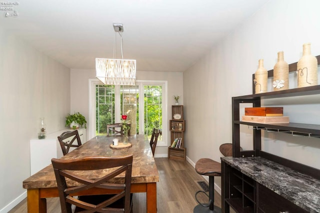 dining room with an inviting chandelier and dark hardwood / wood-style floors