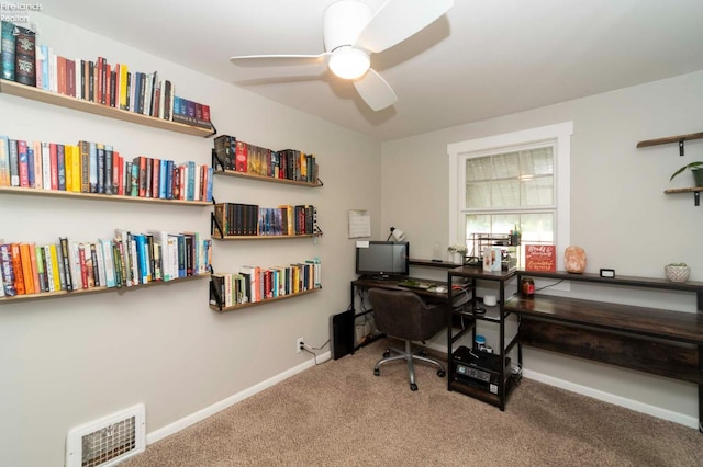 carpeted office space with ceiling fan