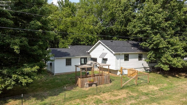 rear view of property with a lawn