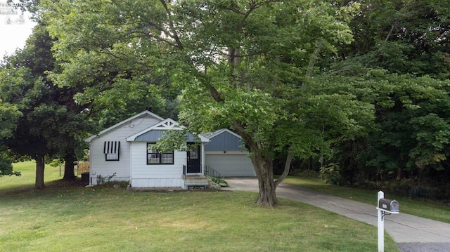 view of front of house with a front yard and a garage