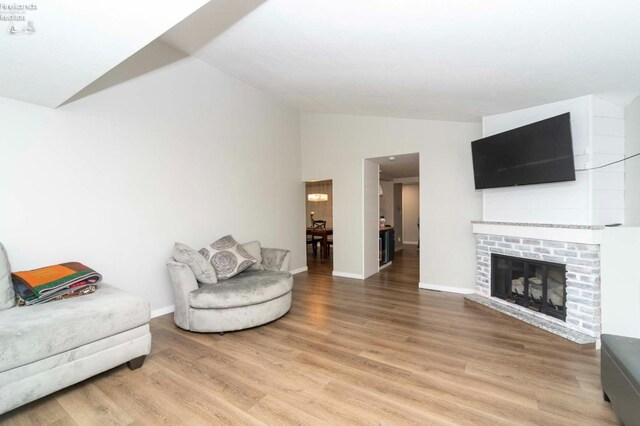 living room featuring light wood-type flooring and lofted ceiling