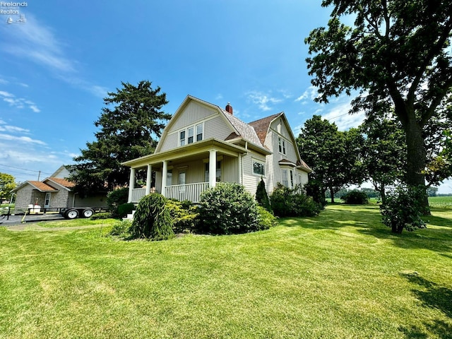 view of side of property featuring a porch, a gambrel roof, roof with shingles, a lawn, and a chimney