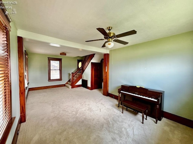 interior space with carpet floors, baseboards, and stairway