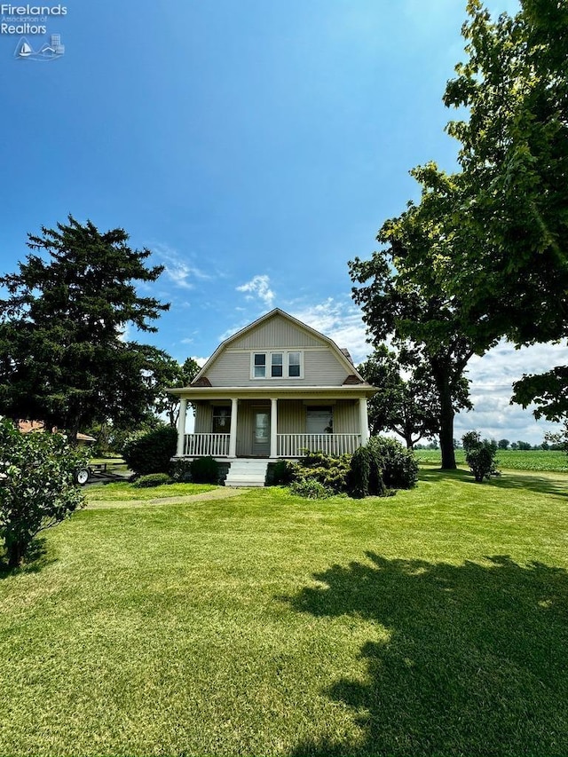 view of front facade with a front lawn and a porch