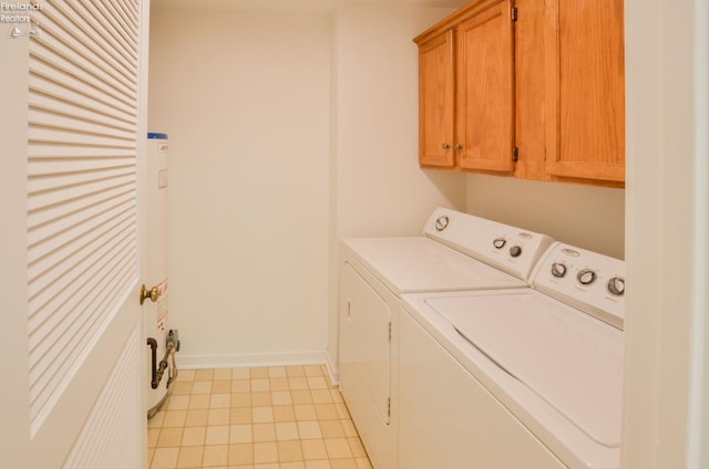 laundry area with washer and clothes dryer, cabinets, and light tile patterned floors