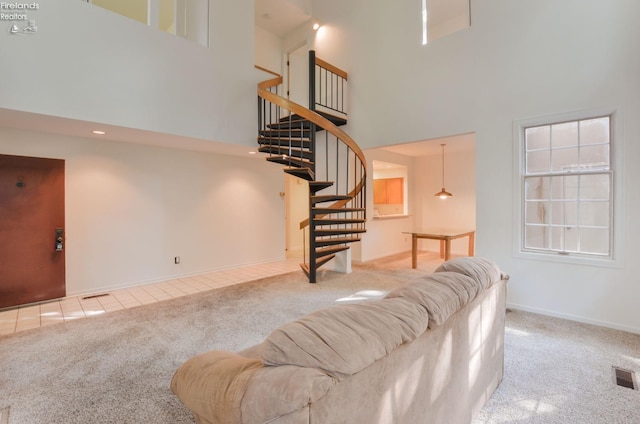 carpeted living room with a high ceiling