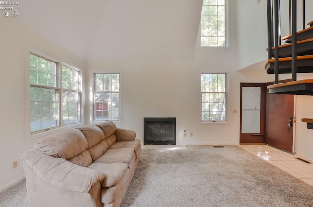 tiled living room featuring a wealth of natural light and high vaulted ceiling