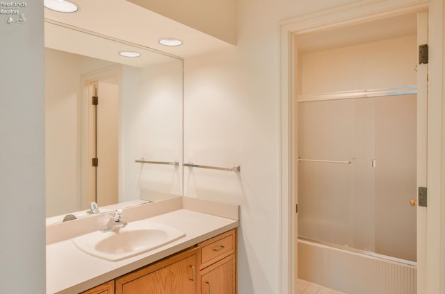 bathroom with tile patterned floors, washtub / shower combination, and vanity