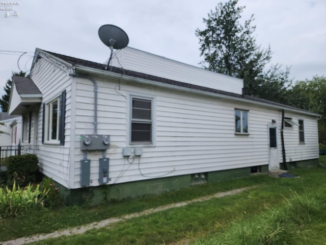 view of home's exterior with a yard