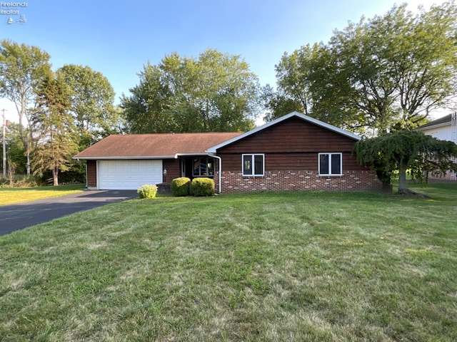 ranch-style house with a garage and a front lawn