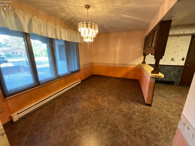 interior space featuring dark tile patterned floors, an inviting chandelier, and a baseboard heating unit