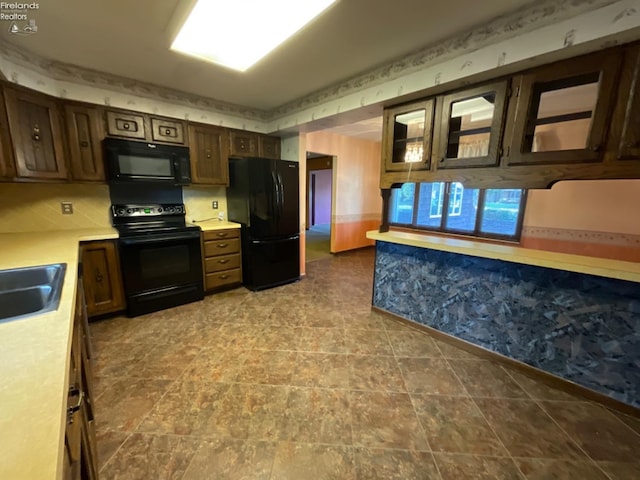 kitchen featuring sink, black appliances, and tile patterned floors