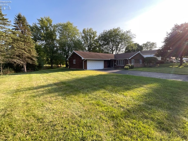 ranch-style house with a garage and a front lawn