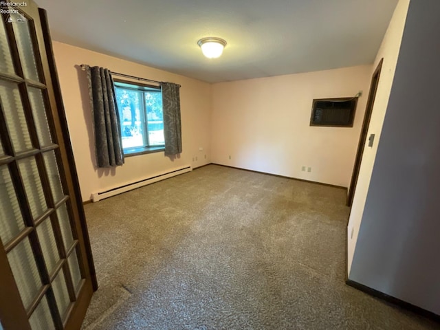 carpeted spare room with baseboard heating