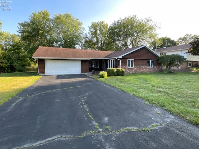 ranch-style home featuring a garage and a front yard