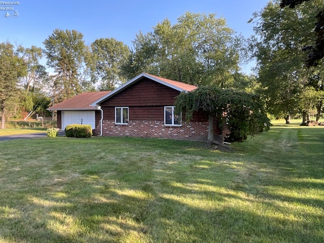 view of home's exterior featuring a garage and a yard