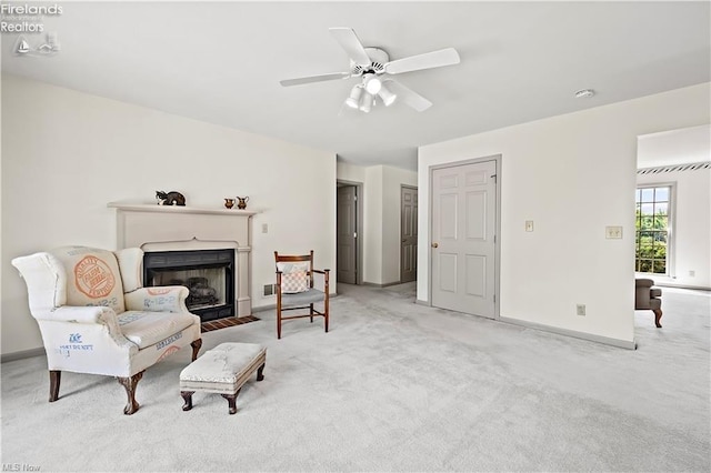 sitting room featuring ceiling fan and light colored carpet