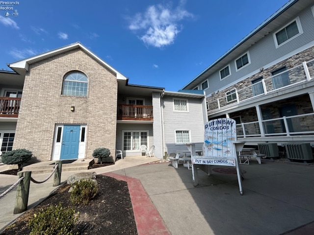 rear view of property featuring central AC and a balcony