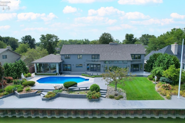 back of house with a patio area and a yard