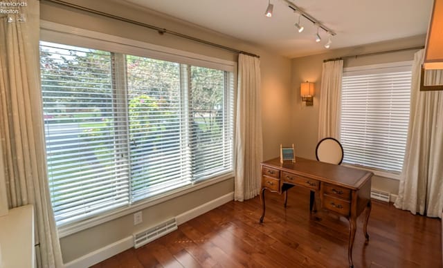 office featuring track lighting, dark hardwood / wood-style flooring, and a baseboard radiator