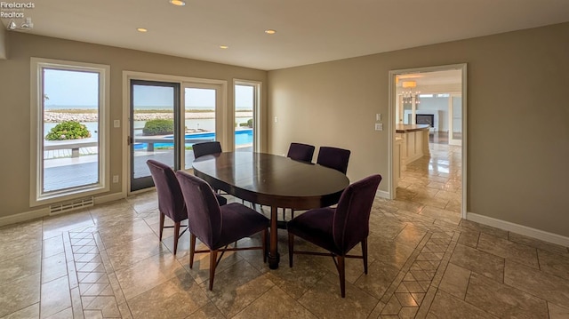 tiled dining room with a chandelier